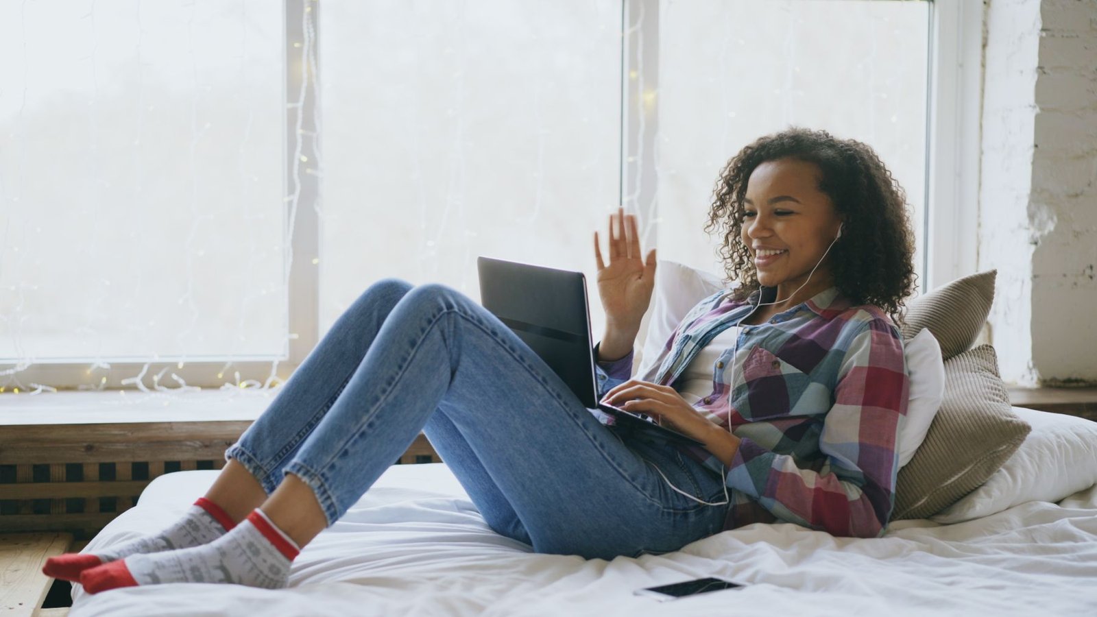 A patient meeting their provider by secure video on a laptop