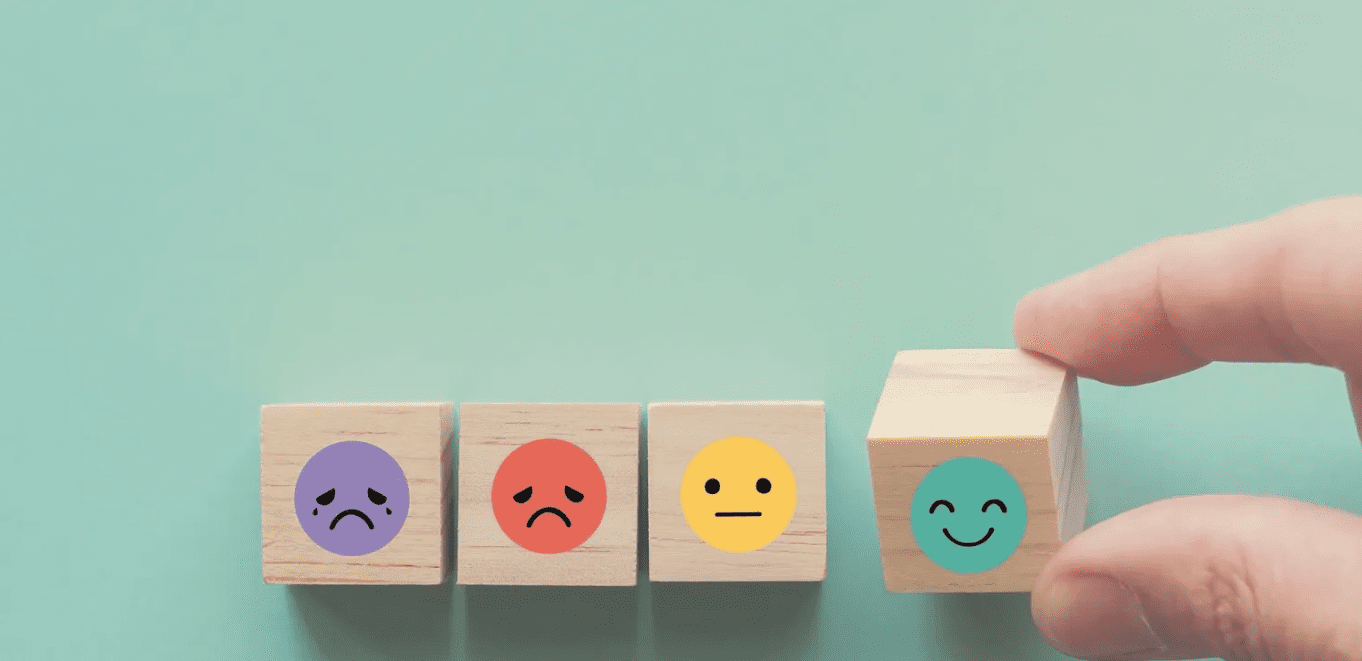 A wooden block with four different colored faces on it.